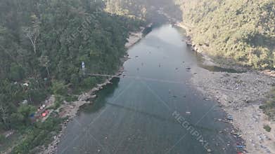 Aerial view of the suspension bridge and clear Umngot River in Shnongpdeng village, a tourist destination in Meghalaya, India