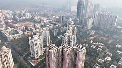 Aerial shot of the Kanakia Challengers towers in Mumbai, with the city skyline obscured by thick haze and pollution
