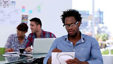Handsome designer drawing on a notepad