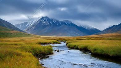 Tundra valley with winding river under mountains and endless expansive sky.
