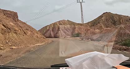 Car driving on mountain area Electric cables