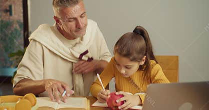 Warm fatherly support while daughter completes school assignment
