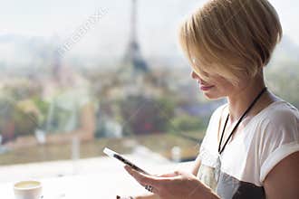Woman smartphone Paris cafe