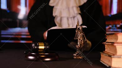 Judge opening law book in courtroom