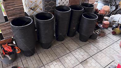 Black Plastic Plant Pots Displayed in Garden Store