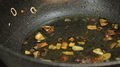 One adds water to the cooking spices. Add water to the food in the pan