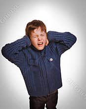 Gray teenager child boy covered his ears screaming opened