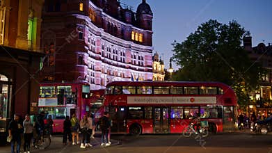 London, England - May 14, 2025: Two red buses driving past t