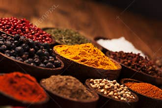 Spices and herbs in wooden bowls.