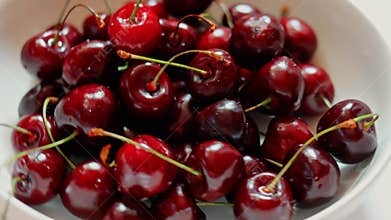 glass plate with ripe cherries close-up