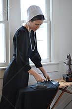 Amish Young Woman Ironing