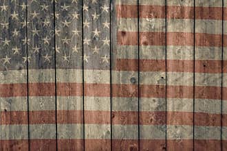 Weathered barn siding with faded painted american flag