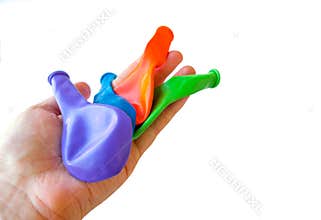 Hand deflated balloons party preparation background isolated white