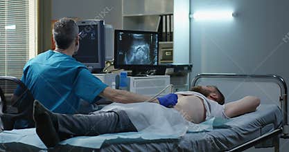 Doctor examining man with ultrasound