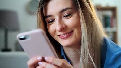 Close up portrait of girl using mobile device browsing the internet, staying connected at home enjoying modern lifestyle