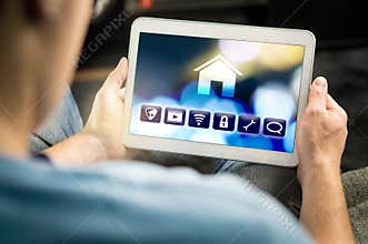 Man using smart home application in tablet to control house