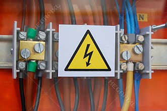 High voltage sign. Electrical relays and wires.