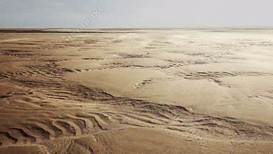 Wind blowing sand over scenic dunes