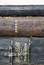 Close Up Three Stacked Leather Antique Bibles with Antique Metal