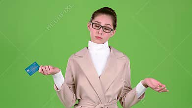 Business lady holding a credit card in her hands has no money. Green screen