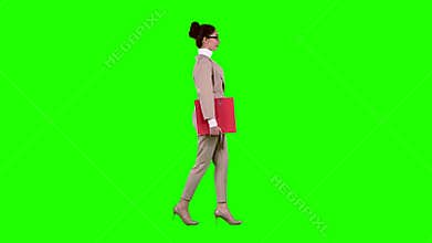 Businessman is going to a meeting with a red folder. Green screen. Side view
