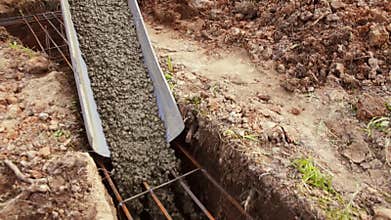 Pouring cement on the Foundation of the cottage during construction