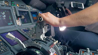 Throttle lever is getting pulled by a pilot of an aircraft