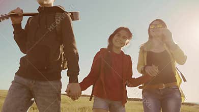 Happy family slow motion video walking on nature boy girl and mom in a field on trekking trip. tourists lifestyle with a