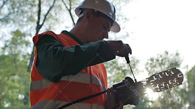 Telecommunications engineer working with optical coupling