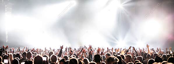 Live concert with raising hands.