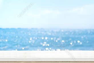 Empty plank white wood table top with blur blue sky and sea boekh background,summer holiday backdrop.Mock up template for display