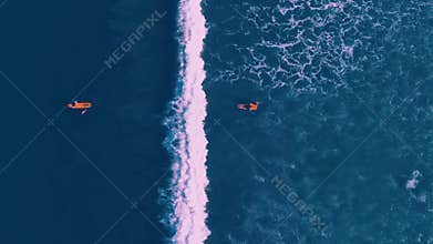 Aerial view of people surfing at Kuta beach, Bali Indonesia