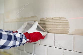Process of tiling the tiles in the kitchen. Home improvement, re