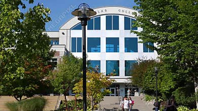 Motion of welcome sign on grass inside campusMotion of students walking on campus