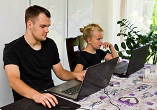 Brother and sister together with laptop computers