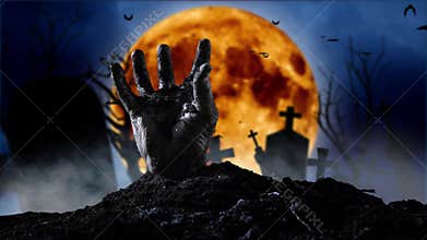 Zombie hand coming out of the grave. Graveyard smoky background