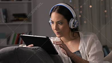 Amazed woman finding videos on tablet