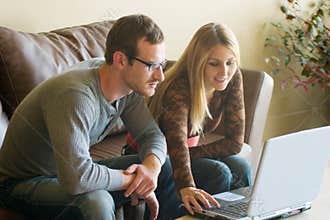 Young Couple Looking At Laptop
