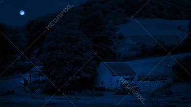 Old farm building in the field at night