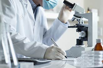Scientist conducting research with microscope