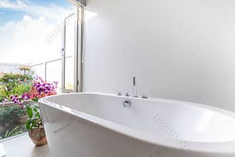 Luxury bathroom features bathtub with flower