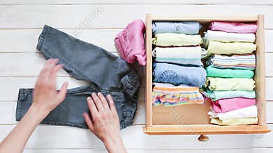 Marie Kondo tyding up method concept - folding kids clothes