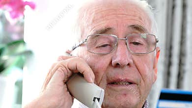 Senior Man Giving Credit Card Details On The Phone