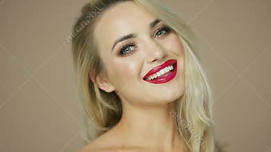 Blonde woman smiling and looking at camera