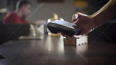 Contactless payment at the cafe.