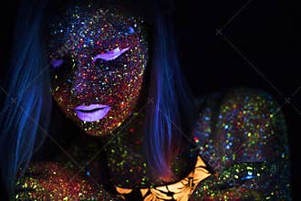 Portrait of Beautiful Fashion Woman in Neon UF Light. Model Girl with Fluorescent Creative Psychedelic MakeUp, Art
