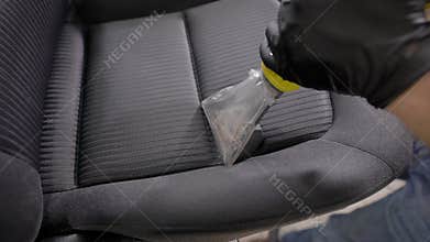 Close up shot of a professional cleaning car seat.