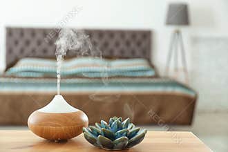 Aroma oil diffuser on table at home