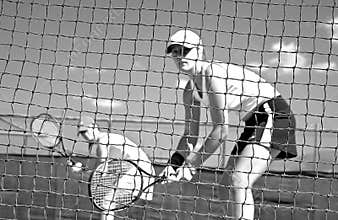 Woman tennis players looking at camera through net waiting to play while looking at camera