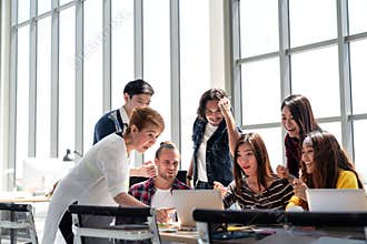 Group of Diversity People Team smiling and excited in success work with laptop at modern office.